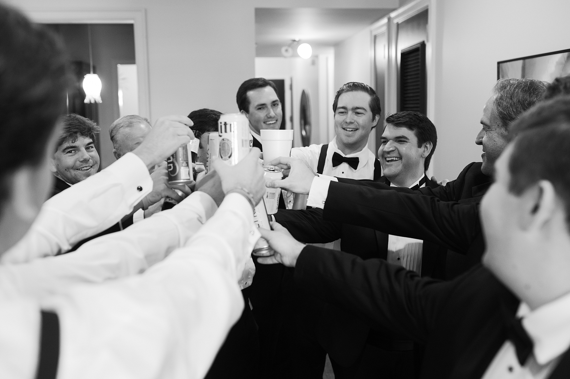groom and groomsmen toast with drinks during prep for Lafayette wedding