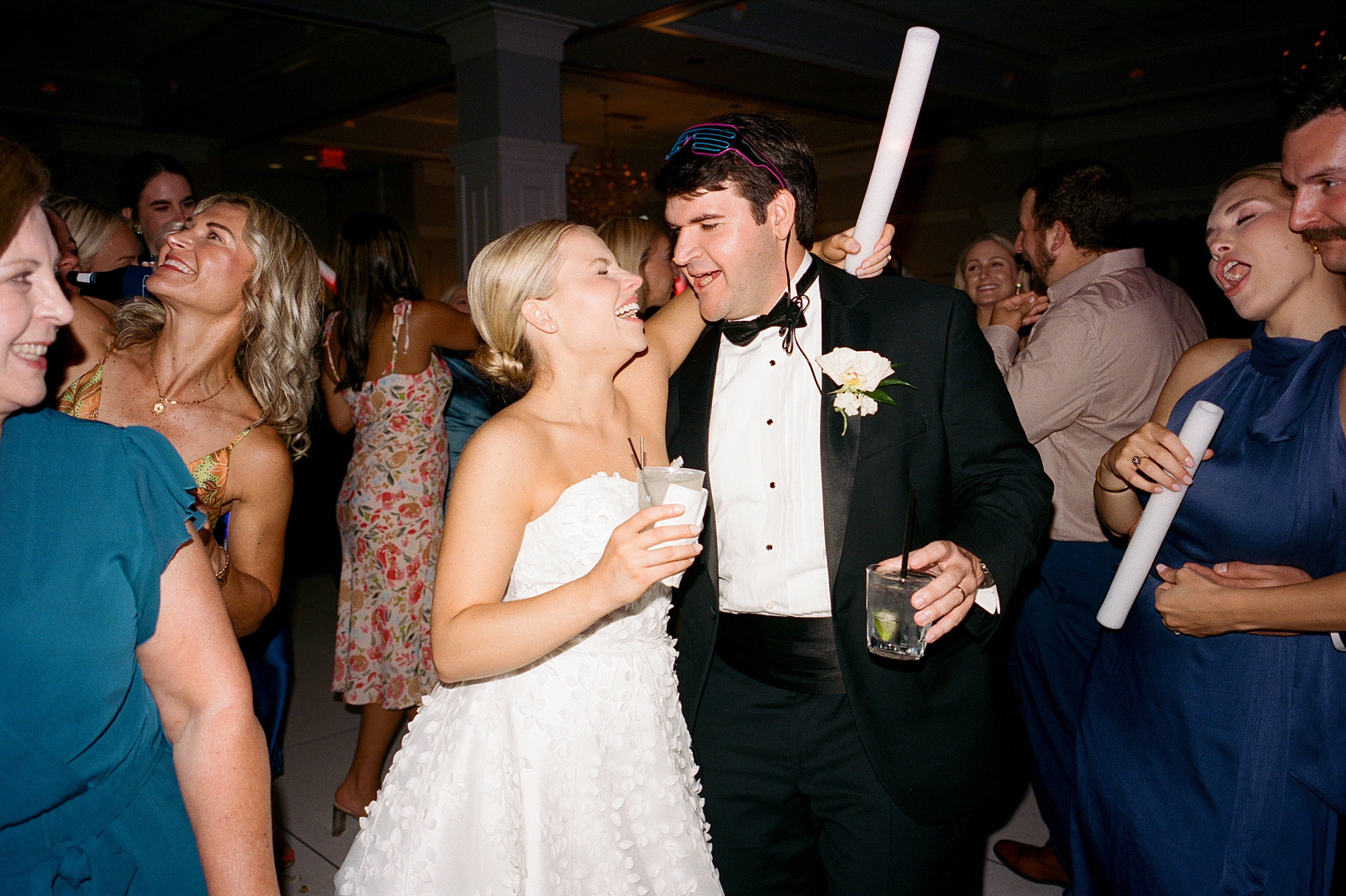 bride and groom laugh on dance floor together during wedding reception in Lafayette LA