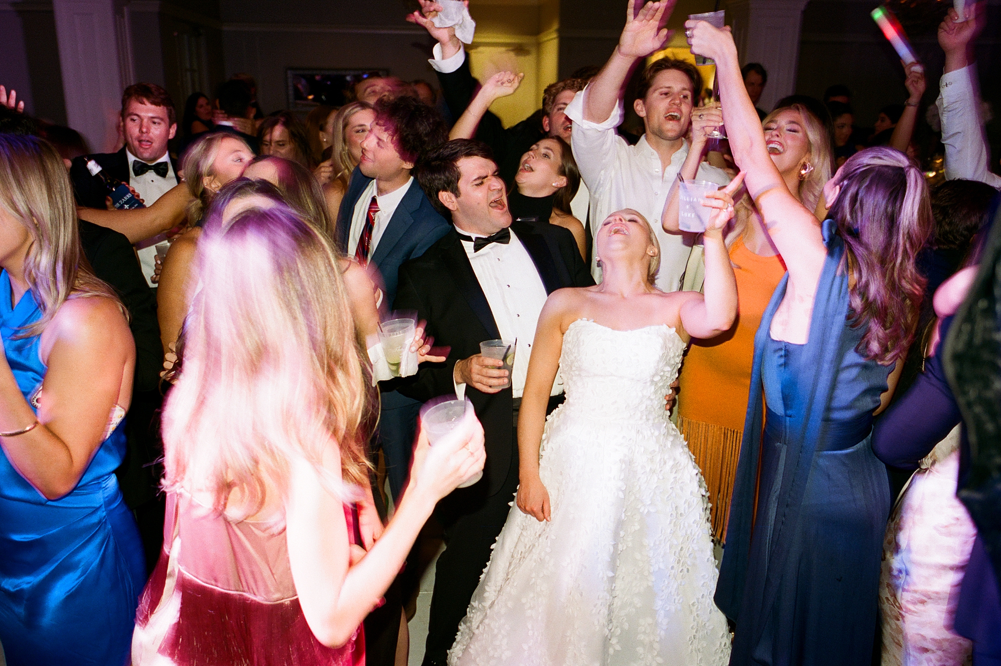 bride and groom dance with guests during wedding reception in Lafayette LA