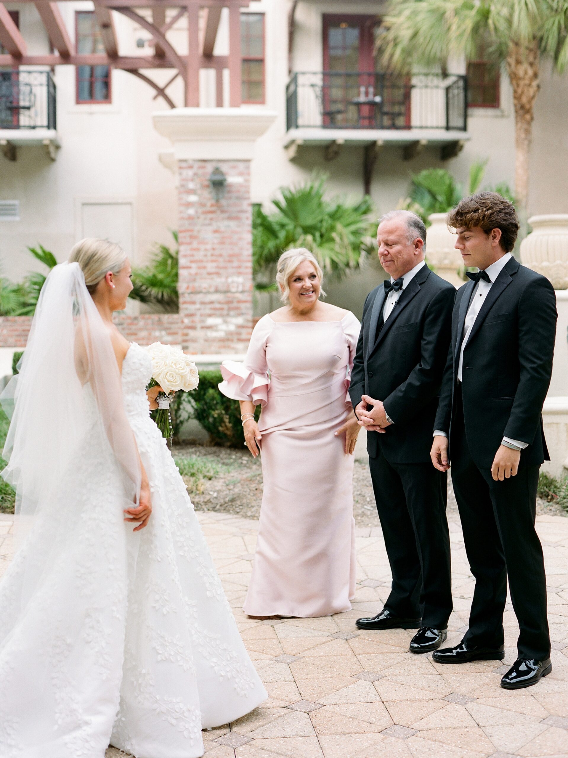 bride approaches dad and brother during first look in Louisiana