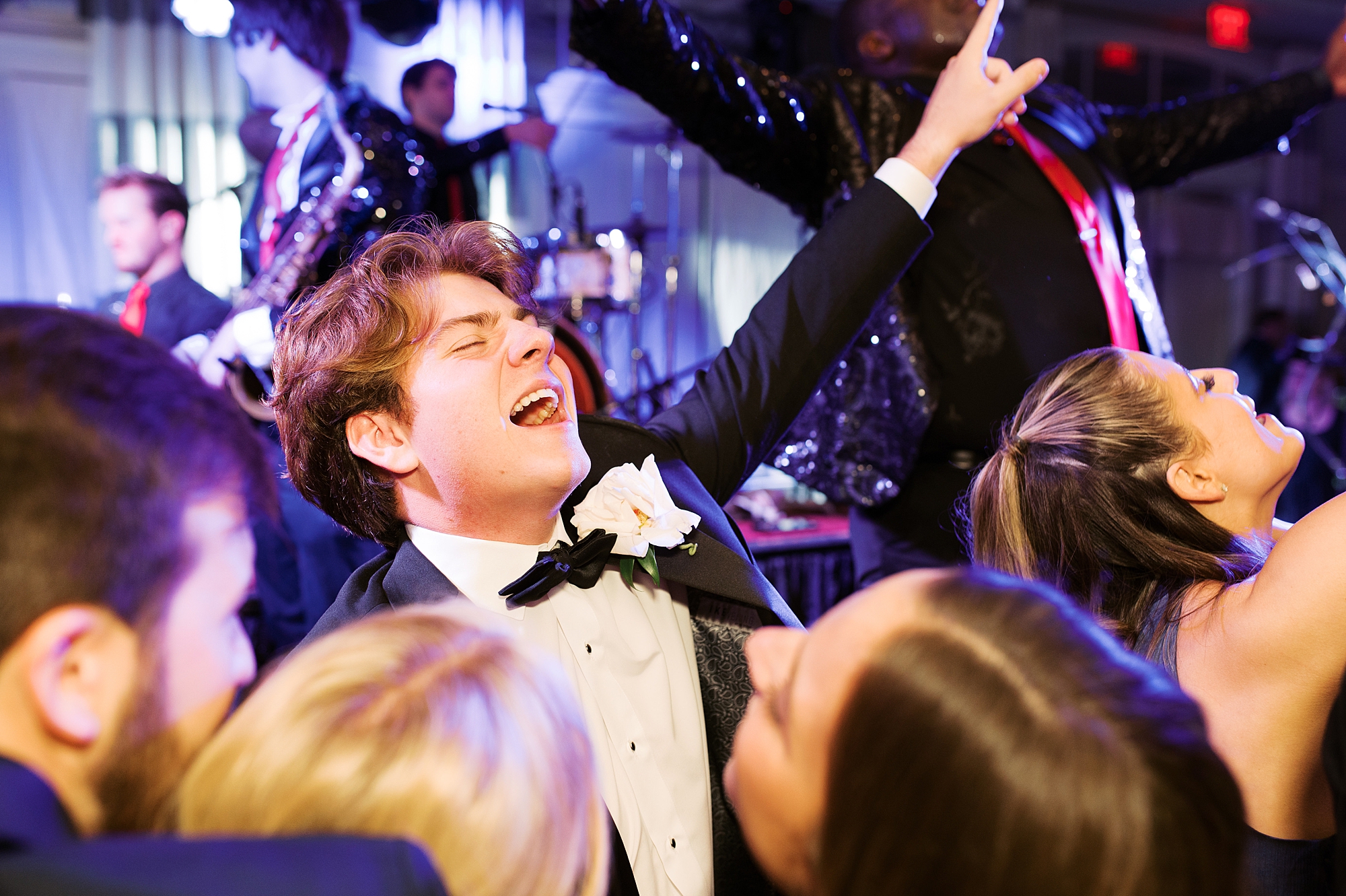 groomsman dances with hands in the air during wedding reception at City Club at River Ranch