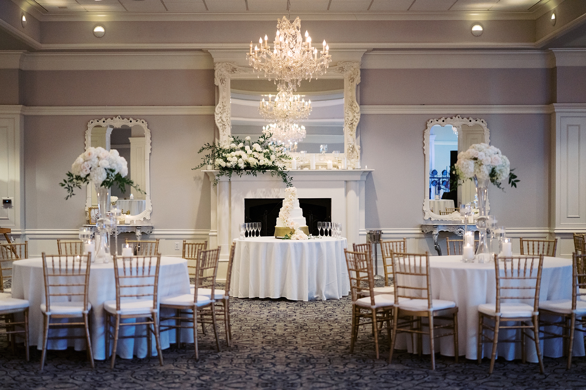 wedding reception at City Club at River Ranch with tall floral arrangements of white and pink flowers  
