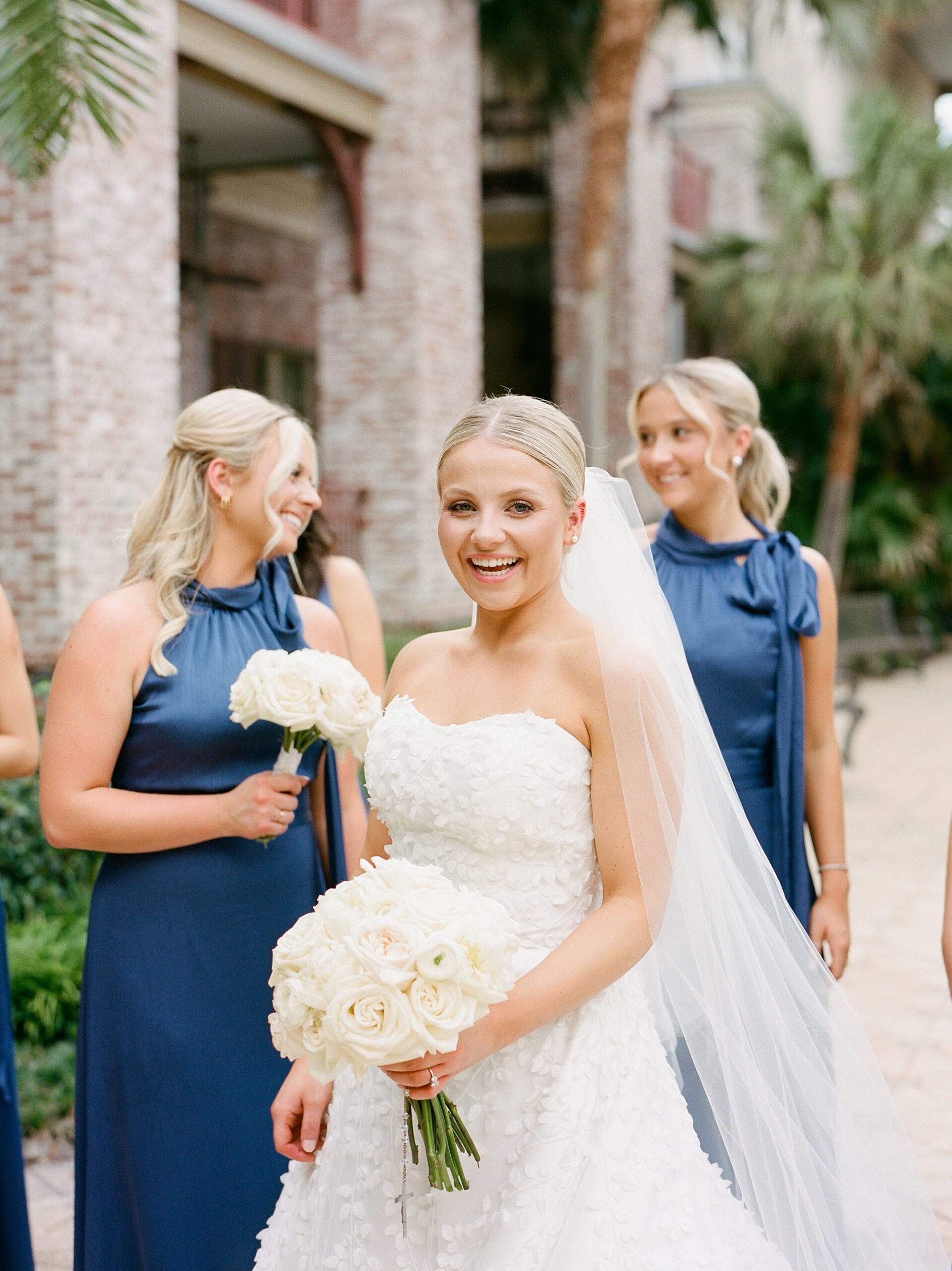 bride laughs standing in front of bridesmaids during Lafayette LA wedding day 