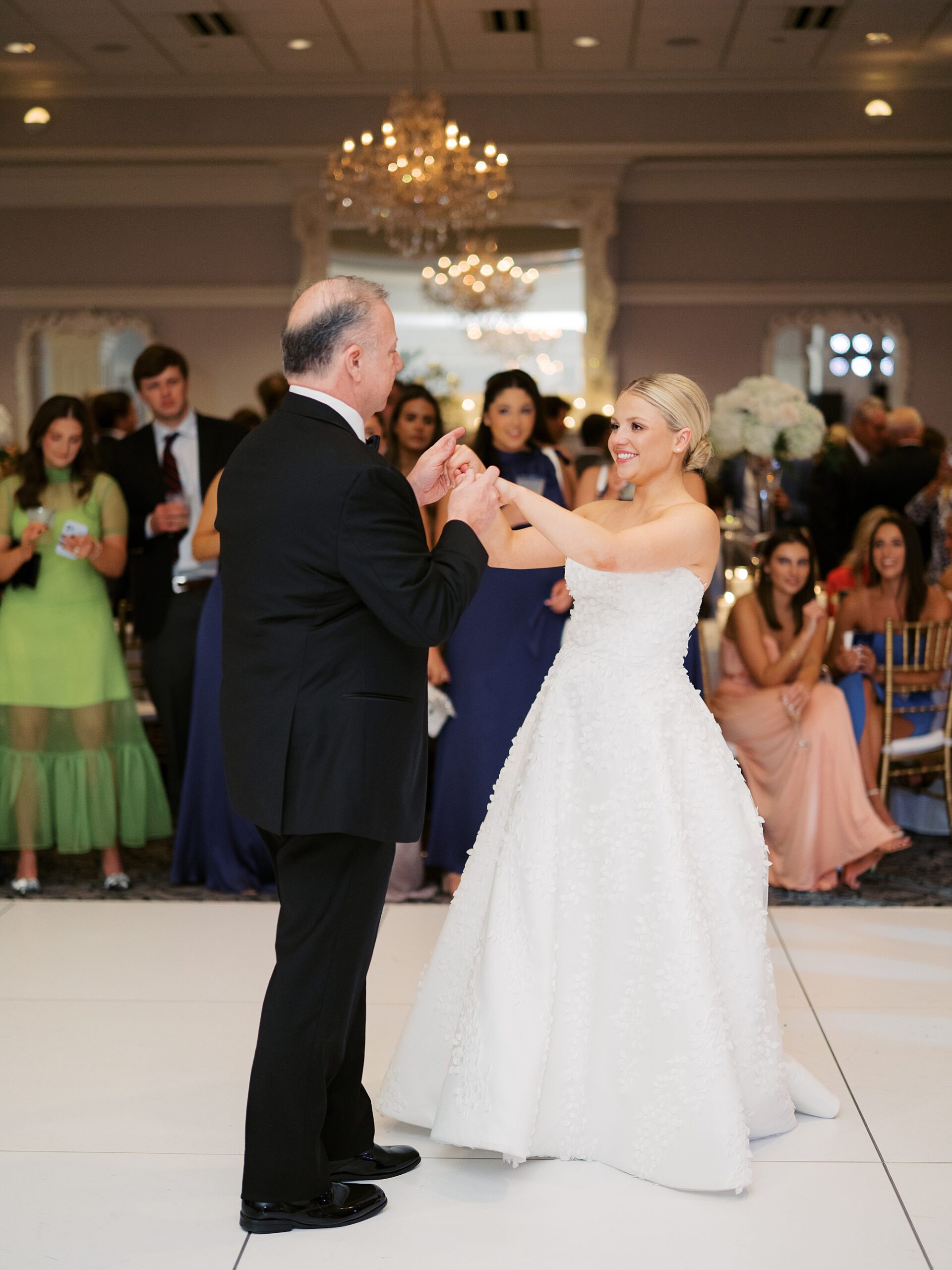 groom twirls bride during dance during wedding reception in Lafayette LA