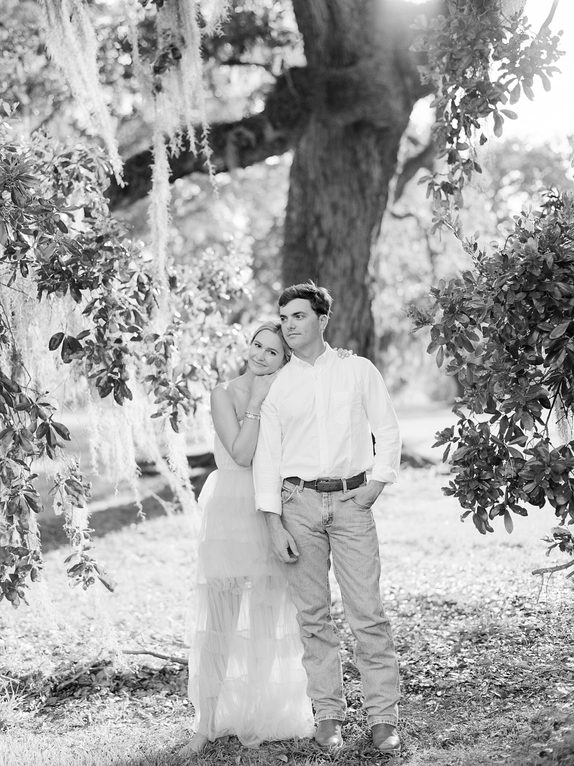 woman leans head on shoulders of fiancee during Sacred Heart of Grand Coteau engagement session 