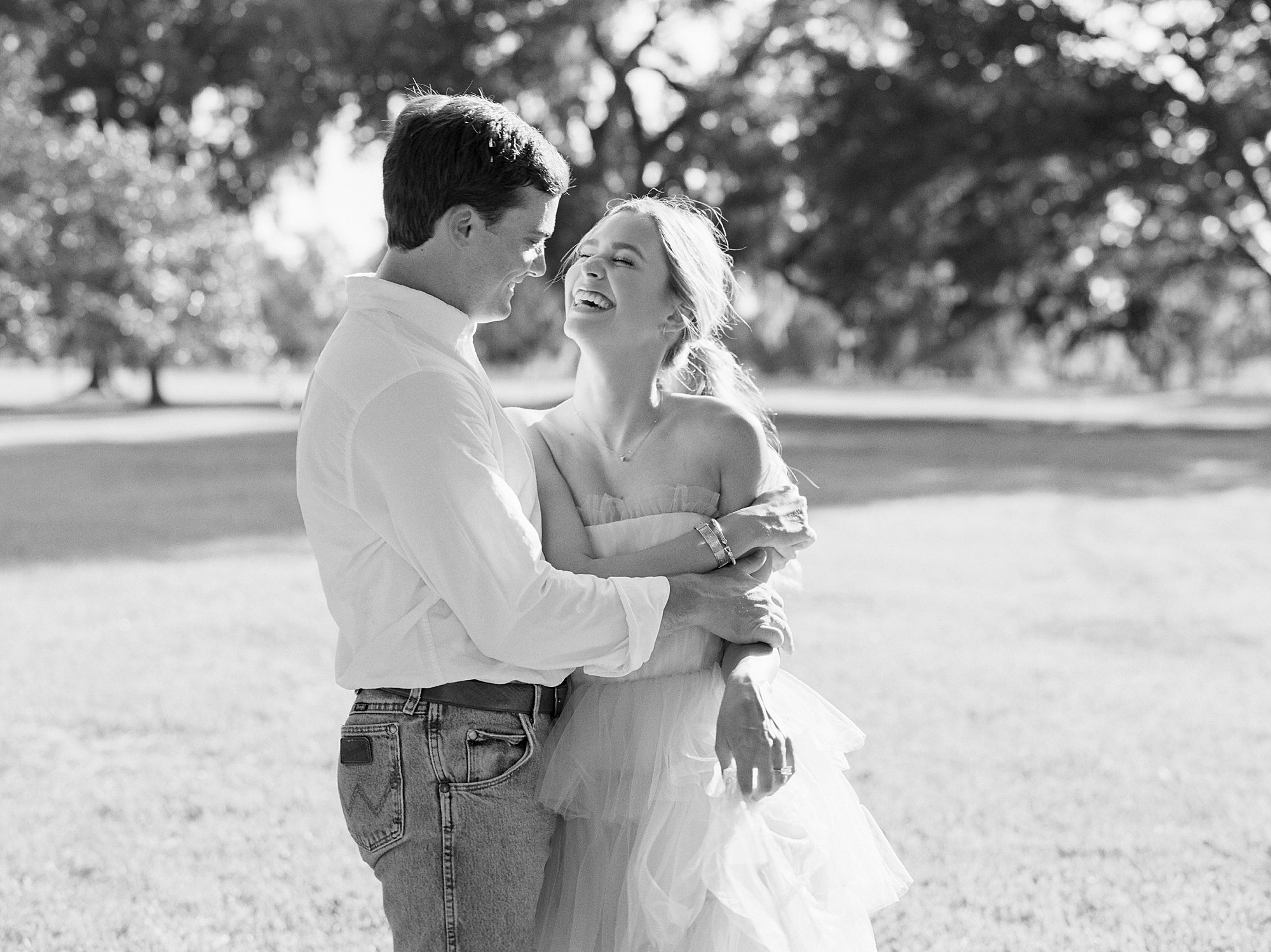 Louisiana couple dances on lawn during engagement photos at Sacred Heart of Grand Coteau