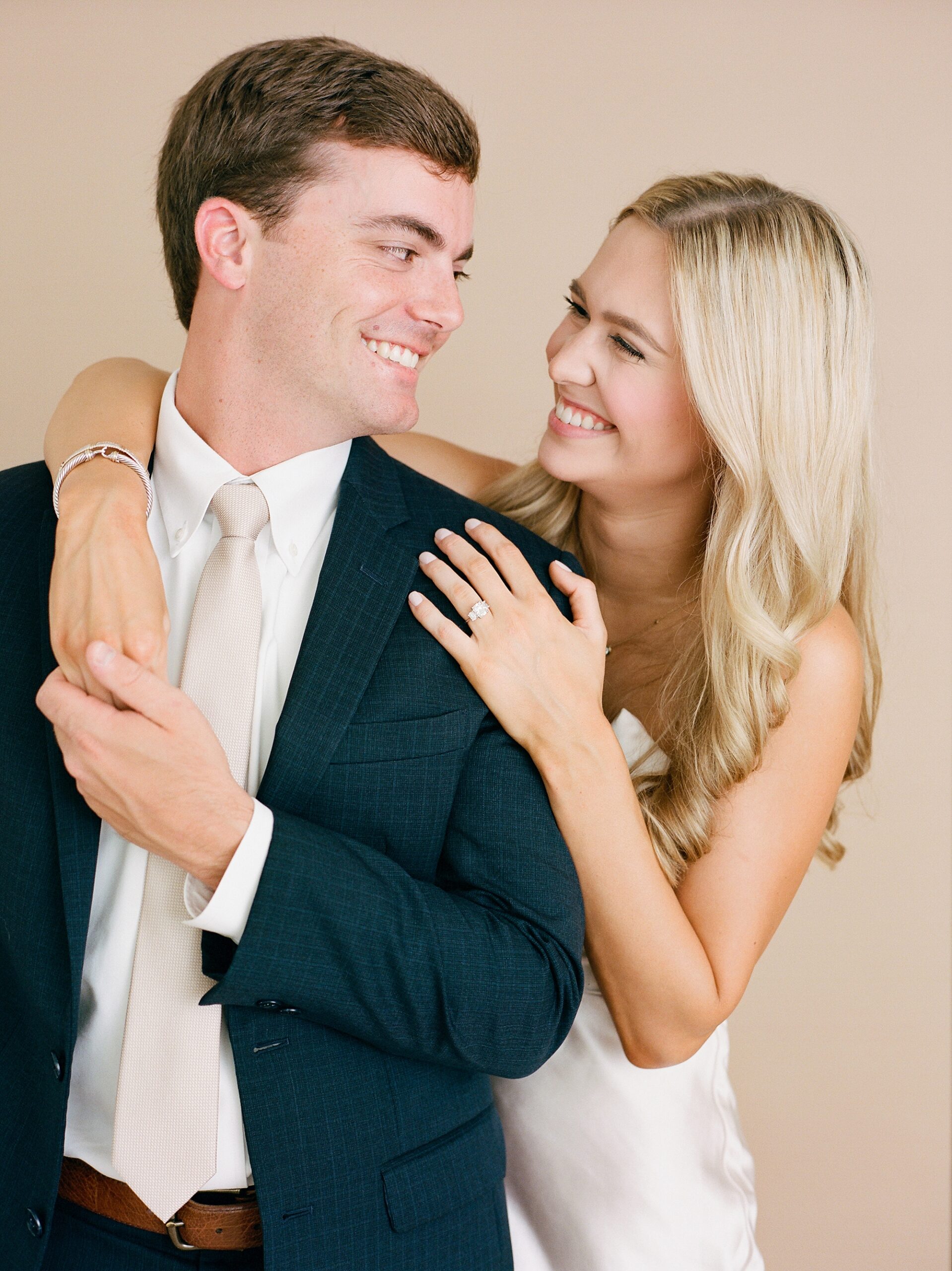 studio engagement portraits in Louisiana for young couple hugging together 