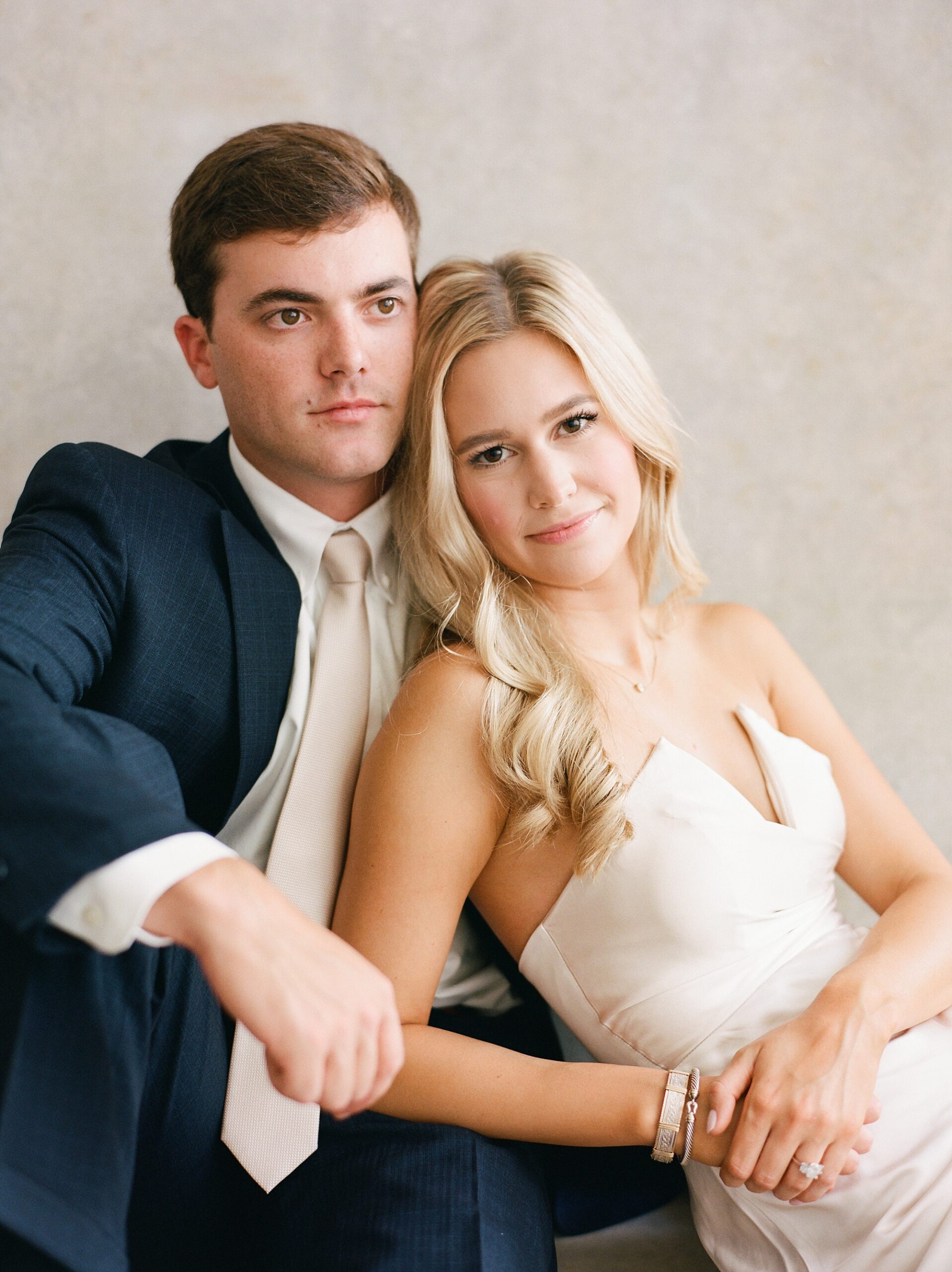 engaged couple sits together during studio engagement portraits in Louisiana 