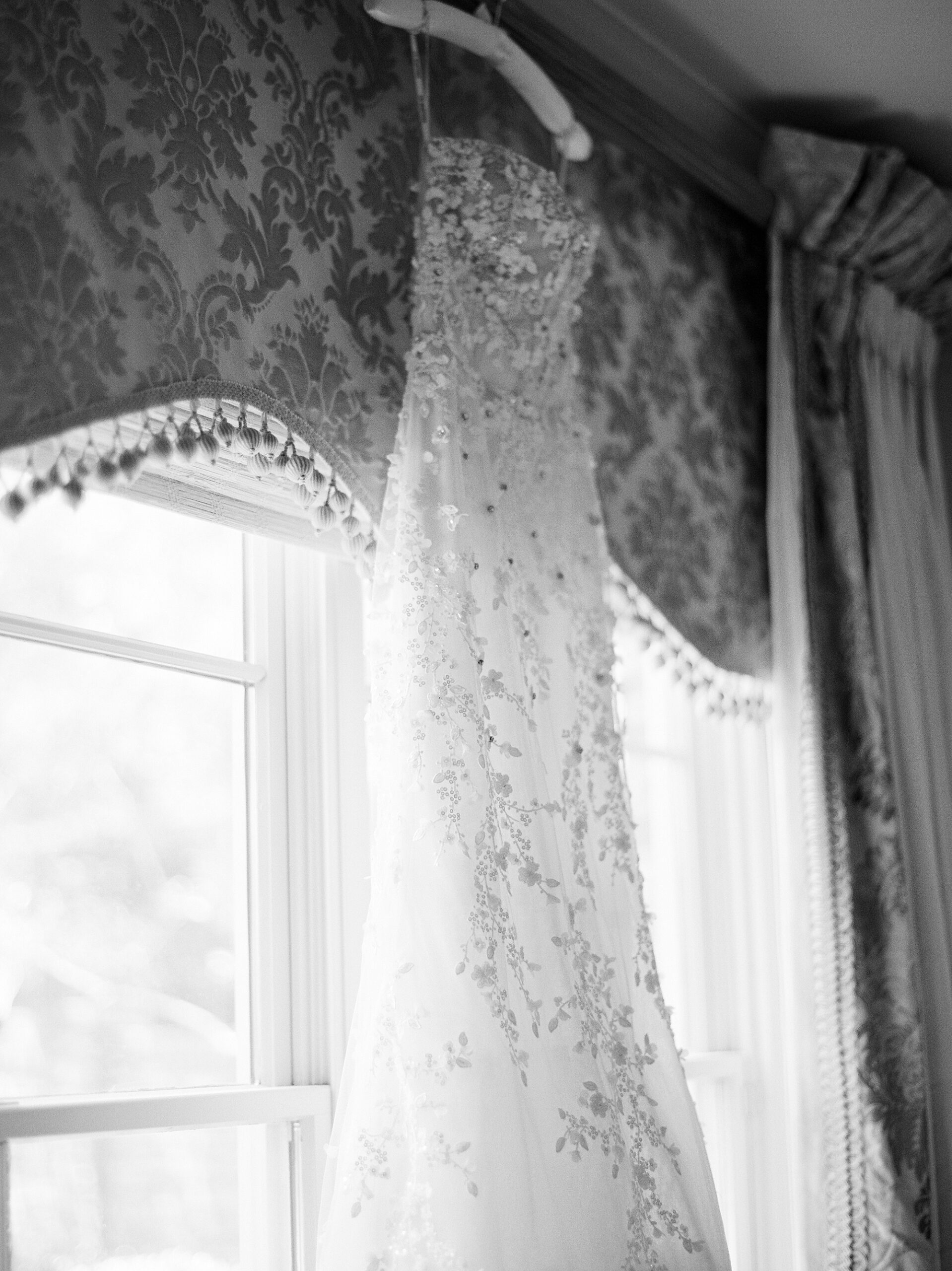 wedding dress hangs in window of Lafayette LA home 