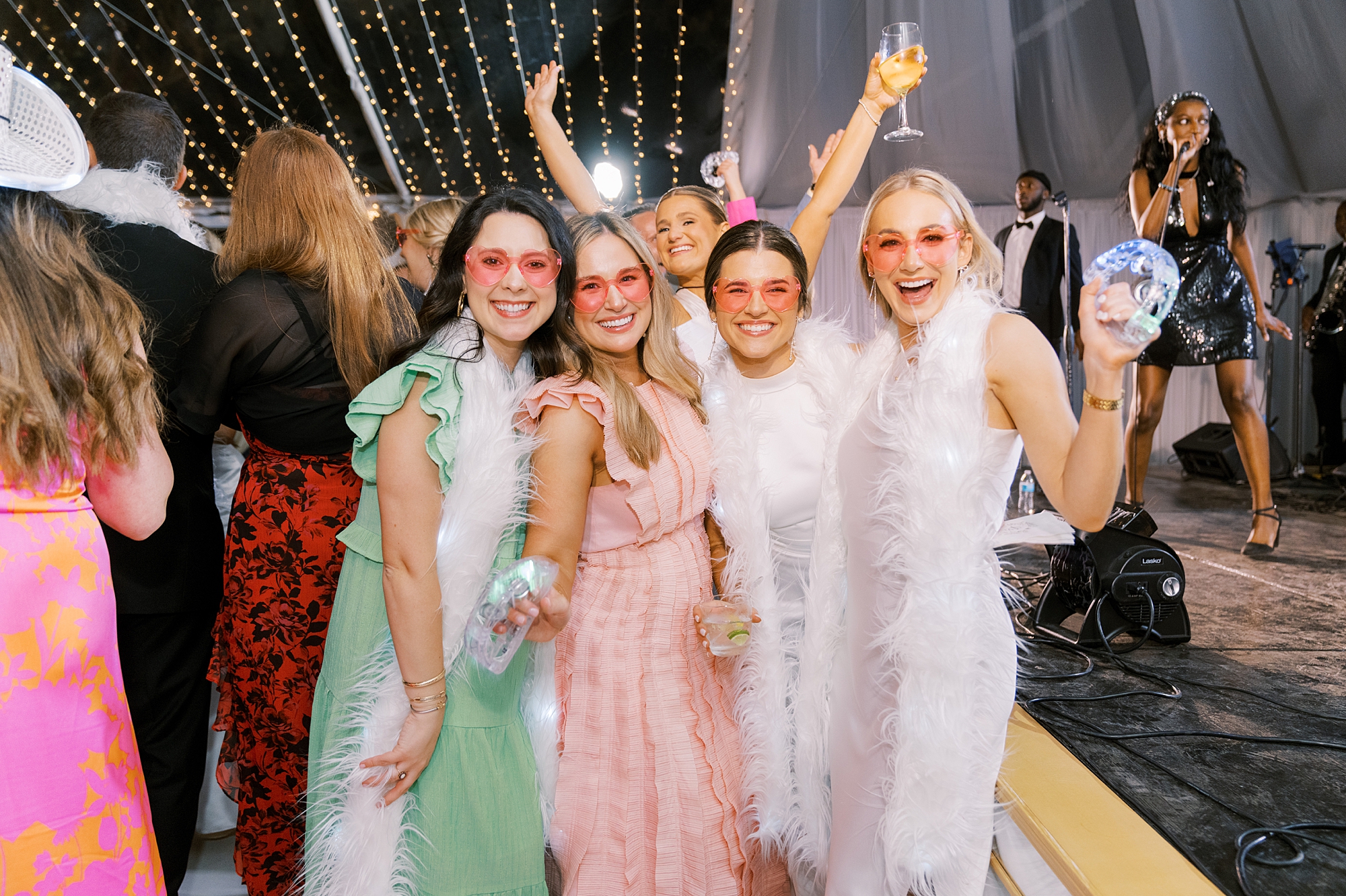 bride poses with friends on dance floor at the University of Louisiana at Lafayette alumni center