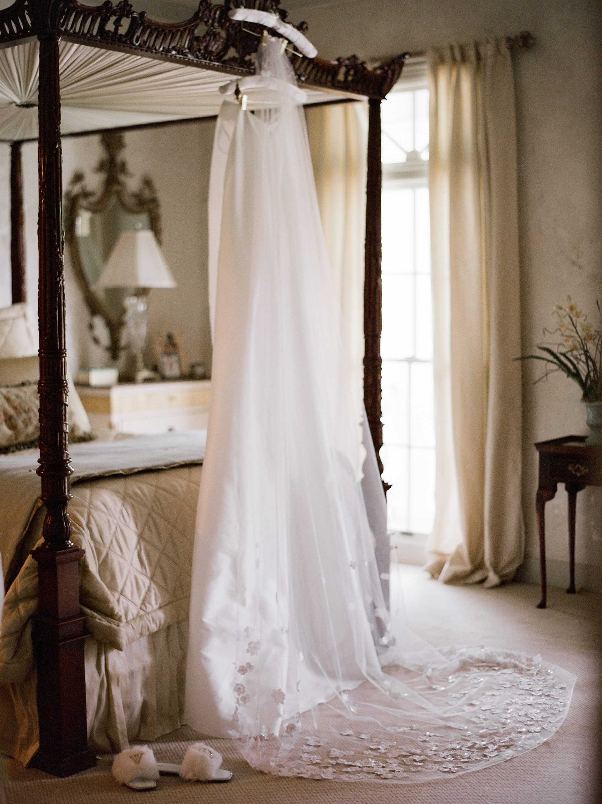 wedding dress hangs on bedframe in Lafayette LA 