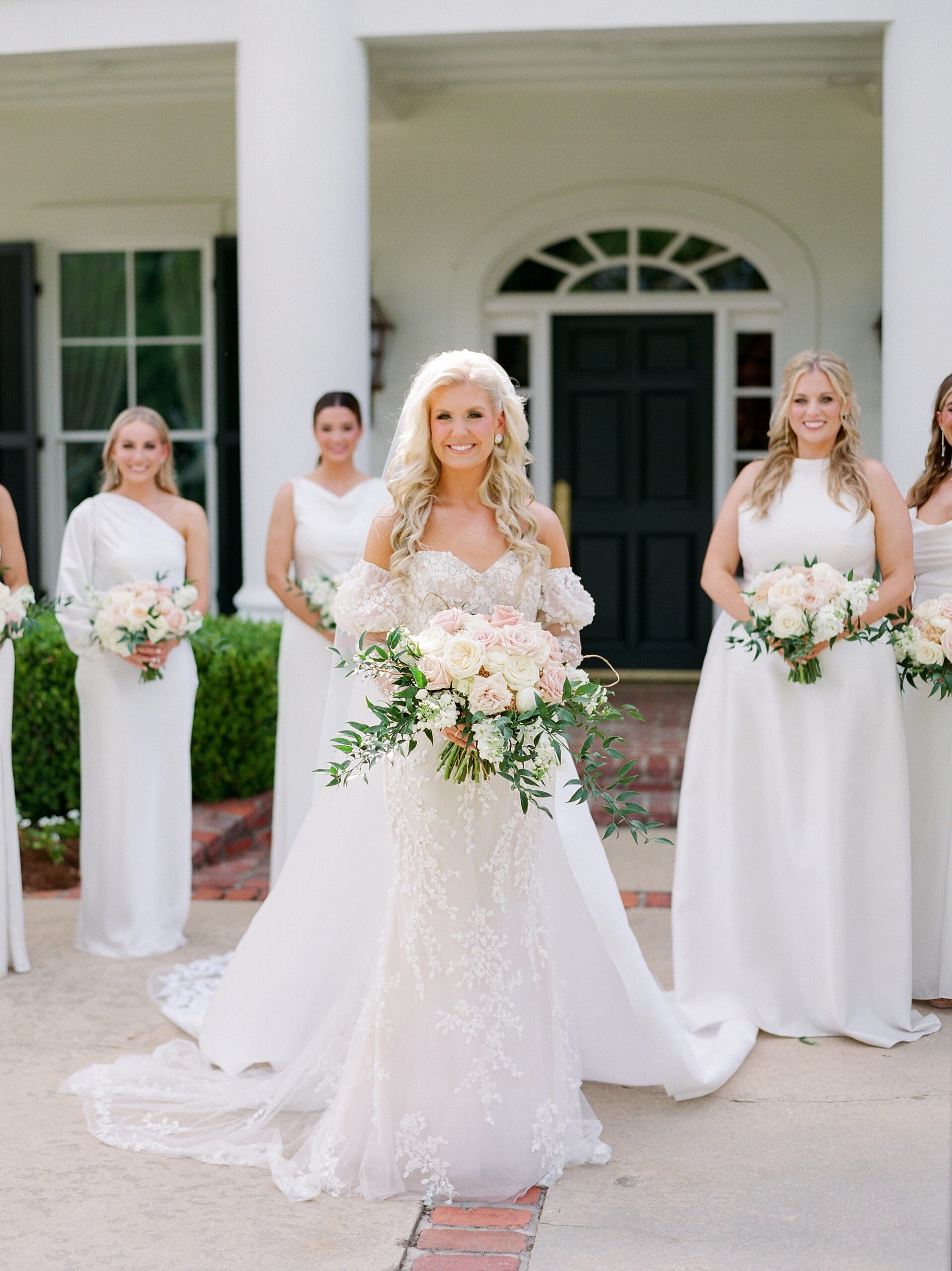 bridesmaids stand with bride outside the University of Louisiana at Lafayette alumni center