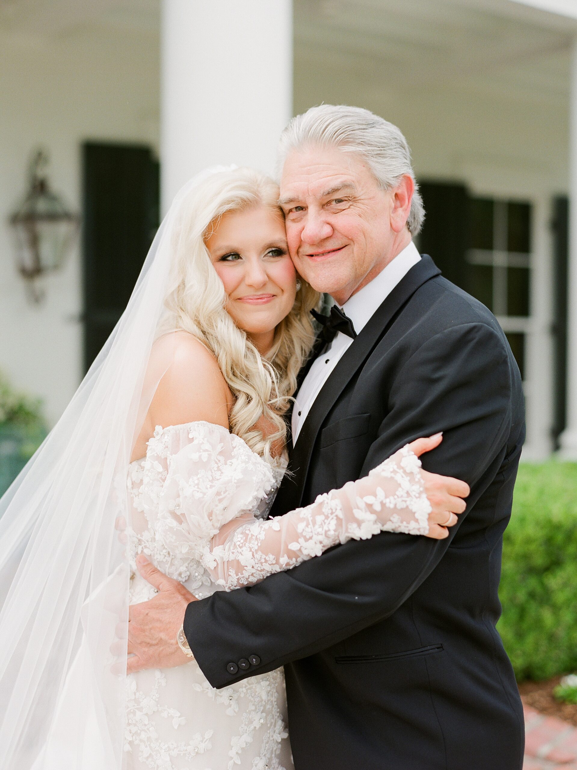 bride and father hug during first look outside the University of Louisiana at Lafayette alumni center