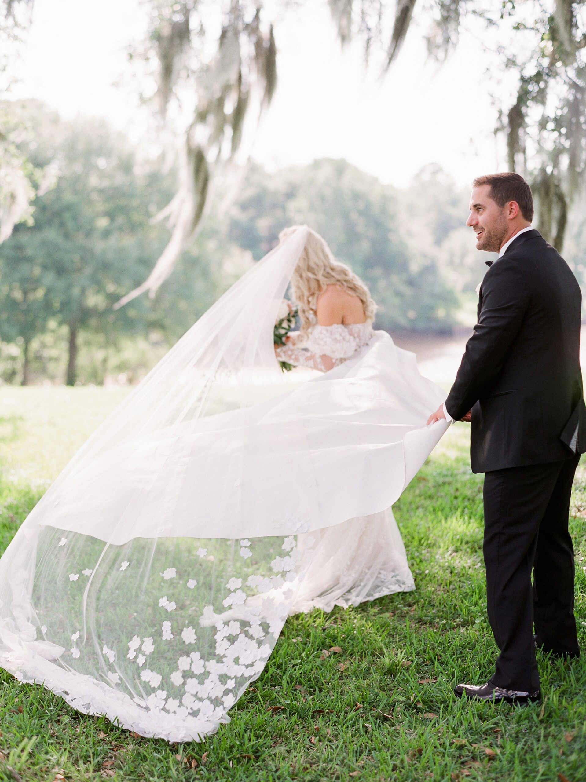 bride twirls in wedding dress showing off gown to groom