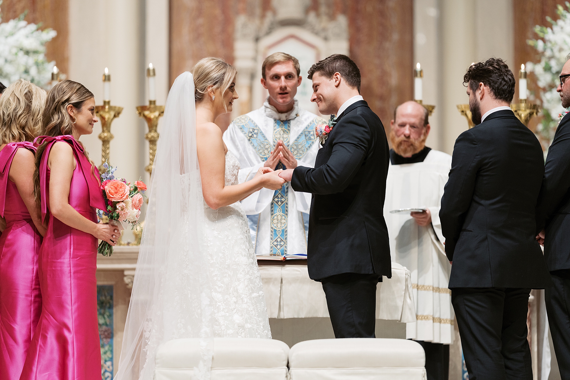 newlyweds exchange rings and vows inside the Cathedral of St. John the Evangelist