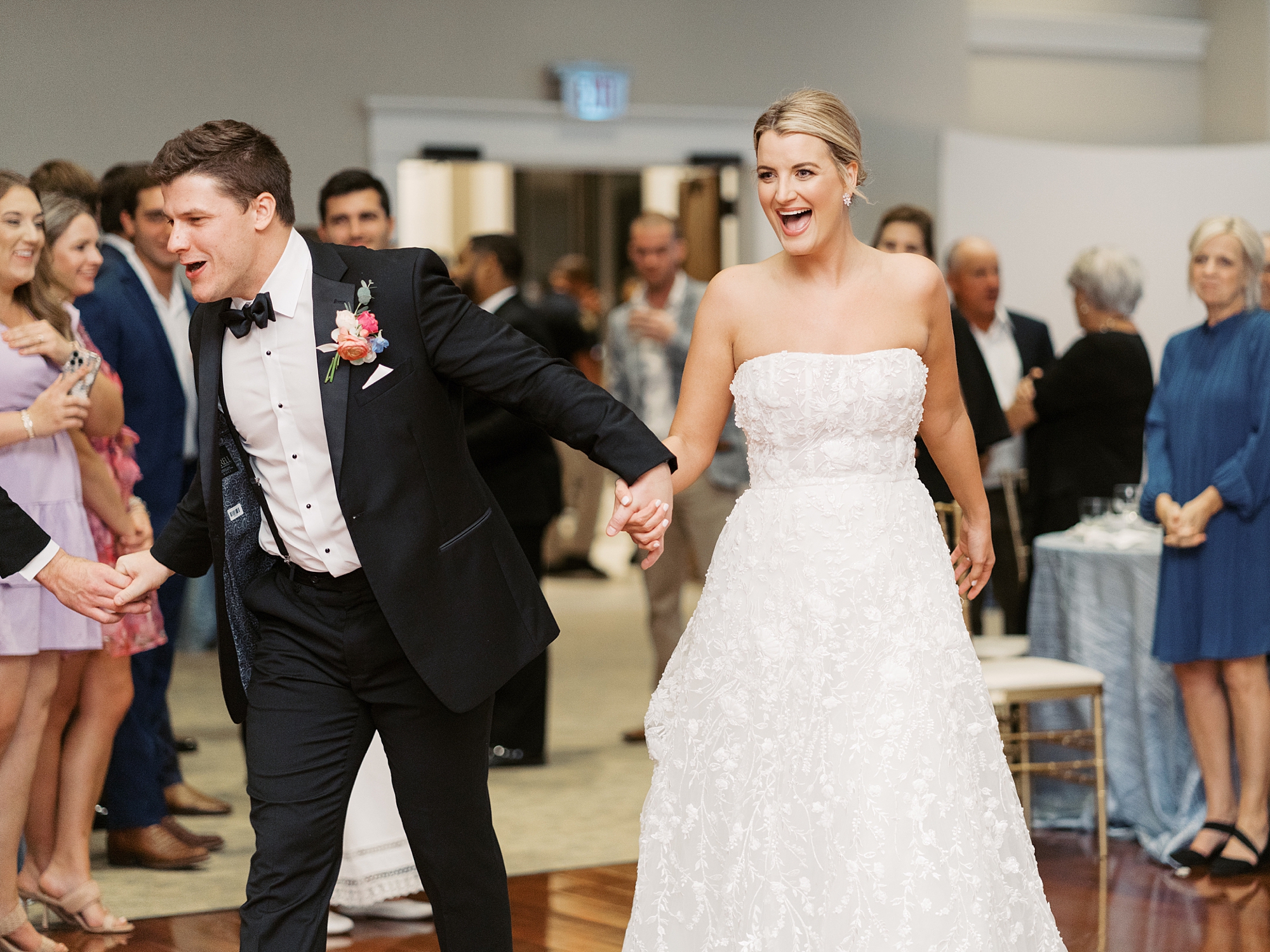 bride and groom laugh entering wedding reception at Le Pavilion Hotel