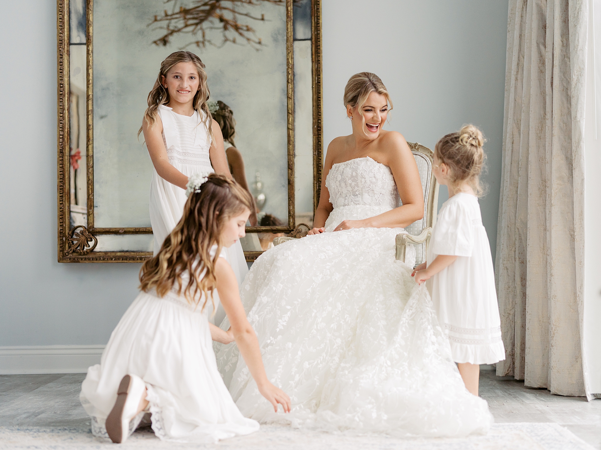 flower girls pose with bride in wedding gown at Le Pavilion Hotel