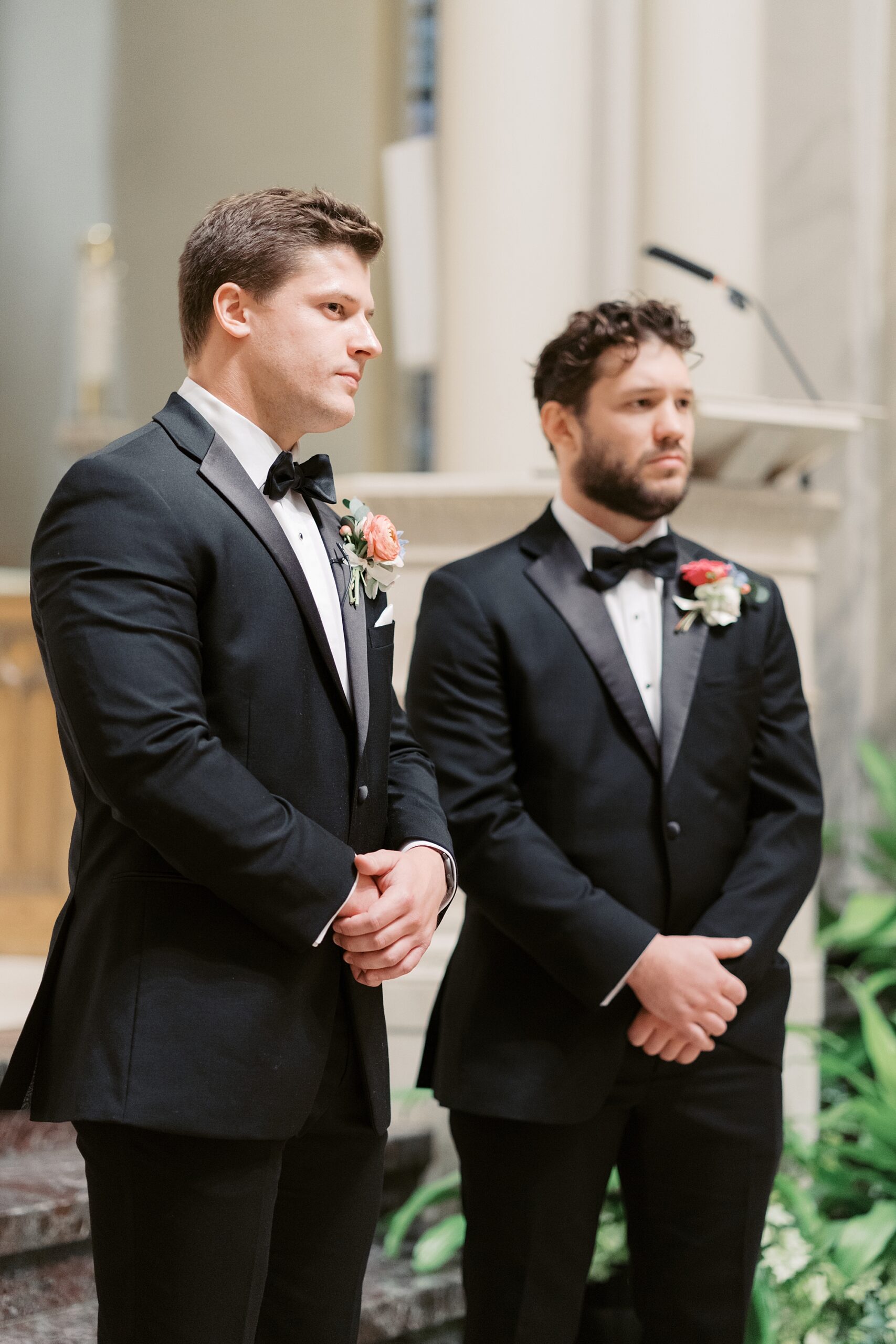 groom and best man stand at alter waiting for bride 
