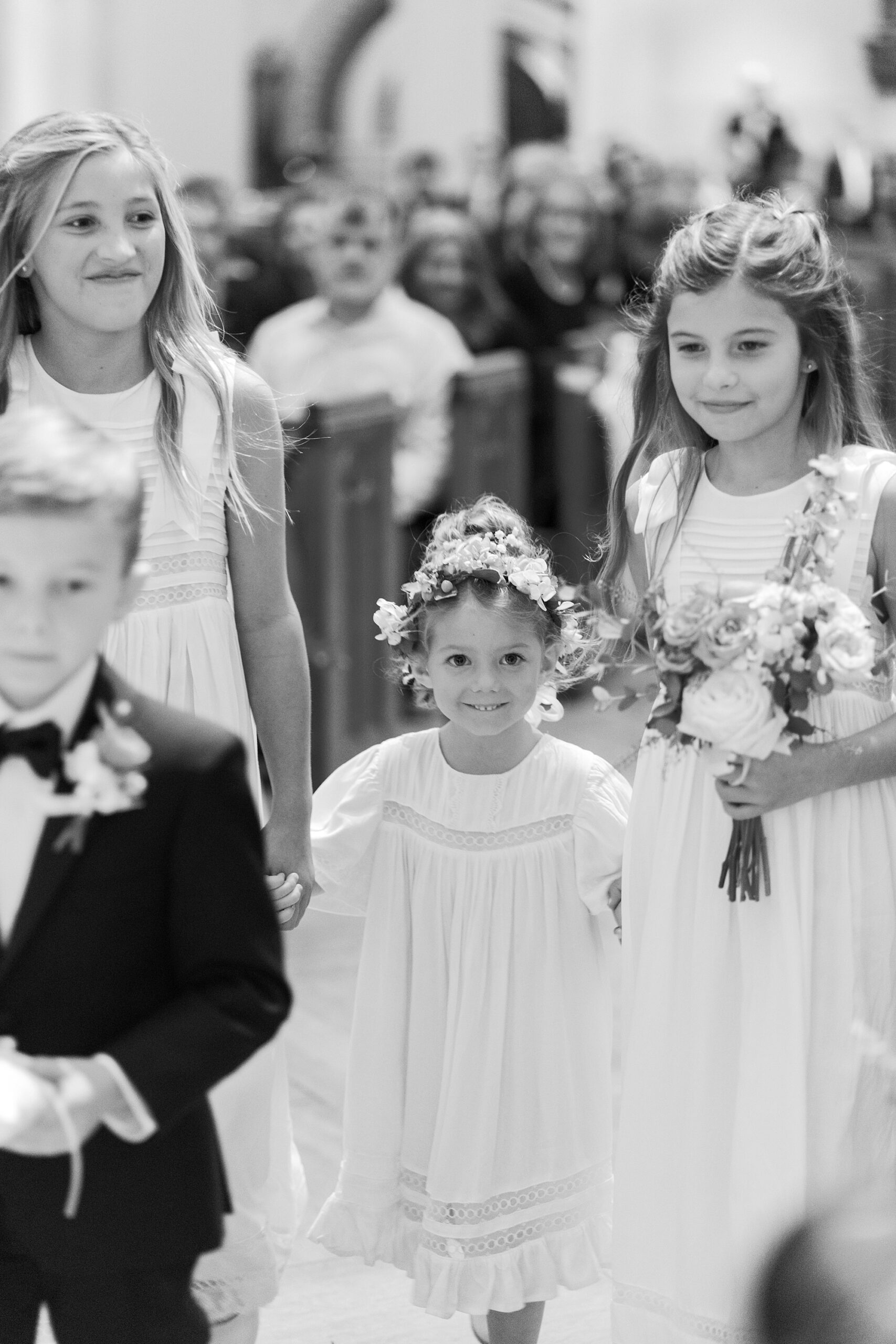 flower girl and ring bearer stand inside  St. John’s Cathedral