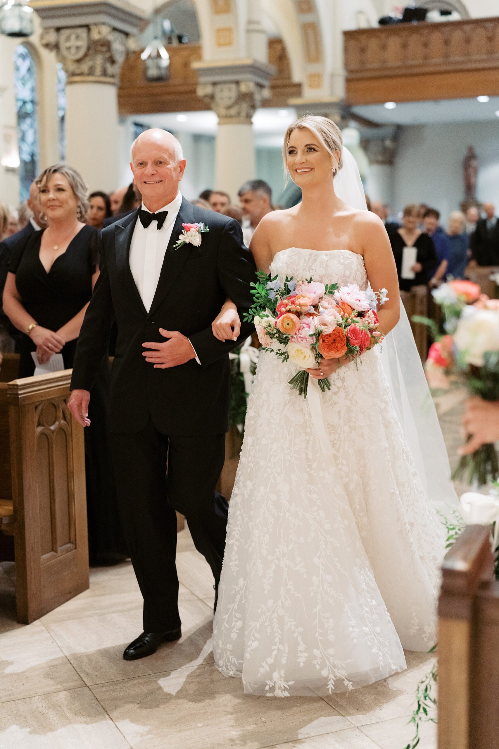 father walks bride down aisle inside the Cathedral of St. John the Evangelist