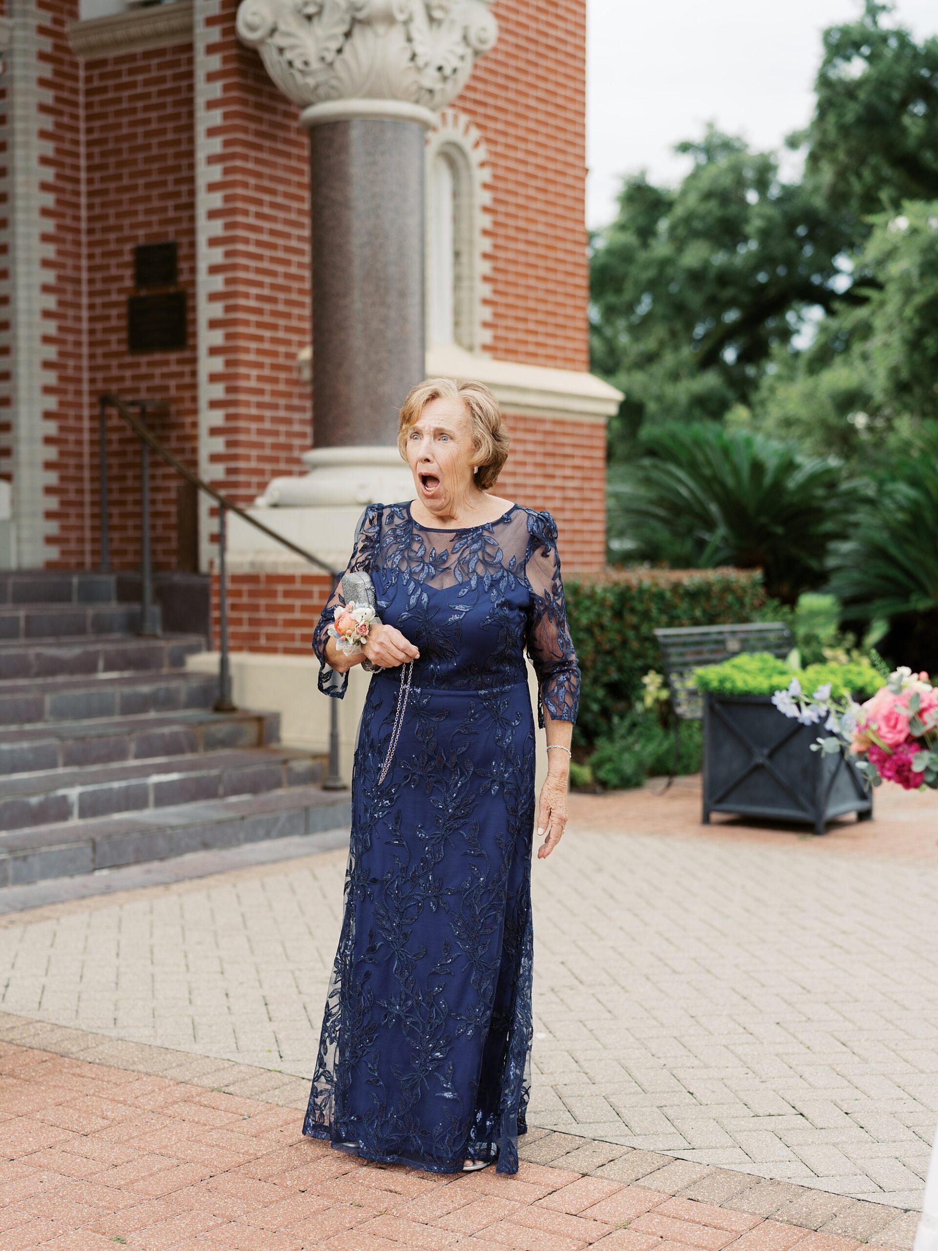 woman in blue dress reacts to seeing bride n wedding day 
