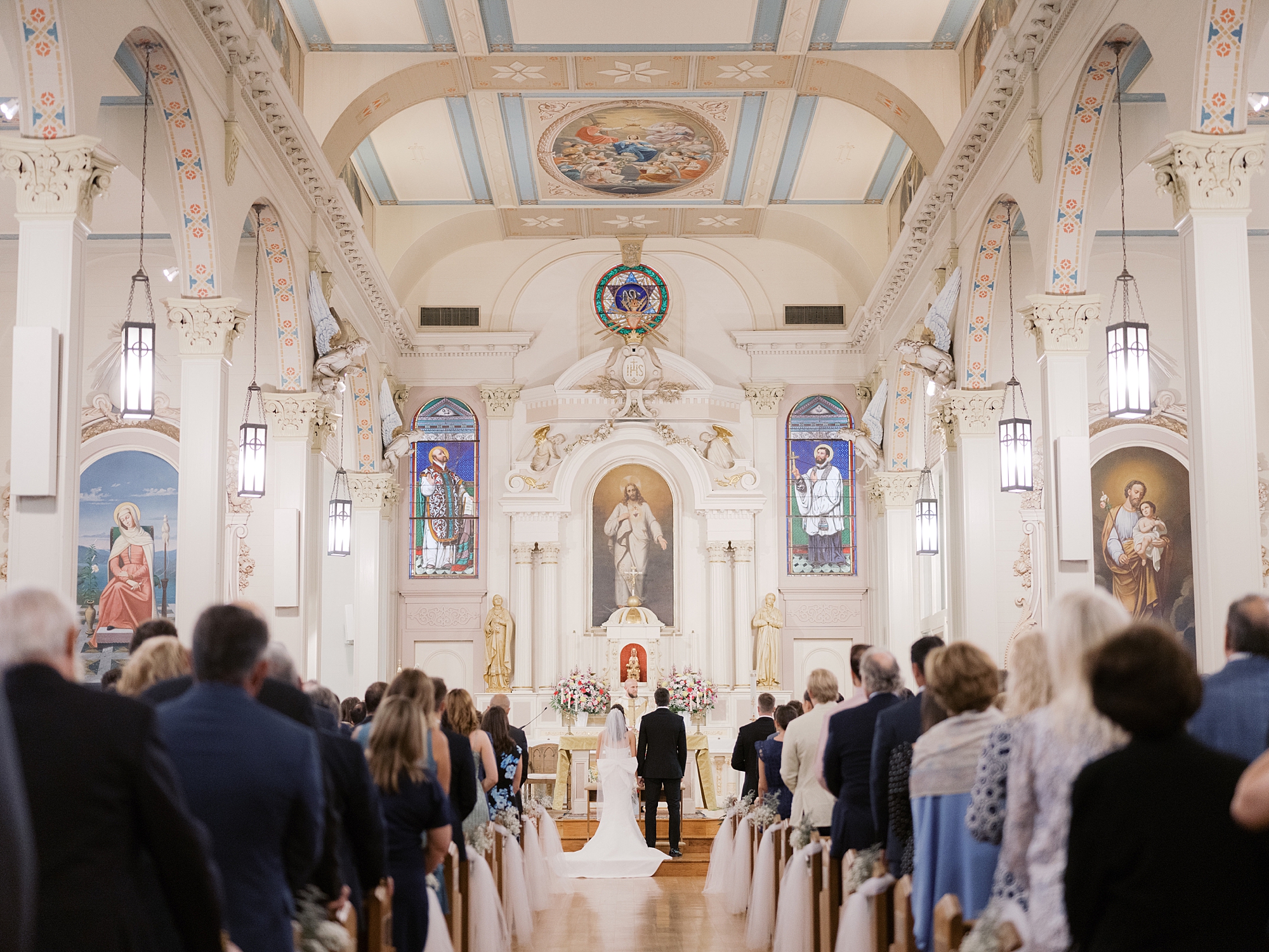 traditional catholic wedding ceremony inside St. Charles Borromeo