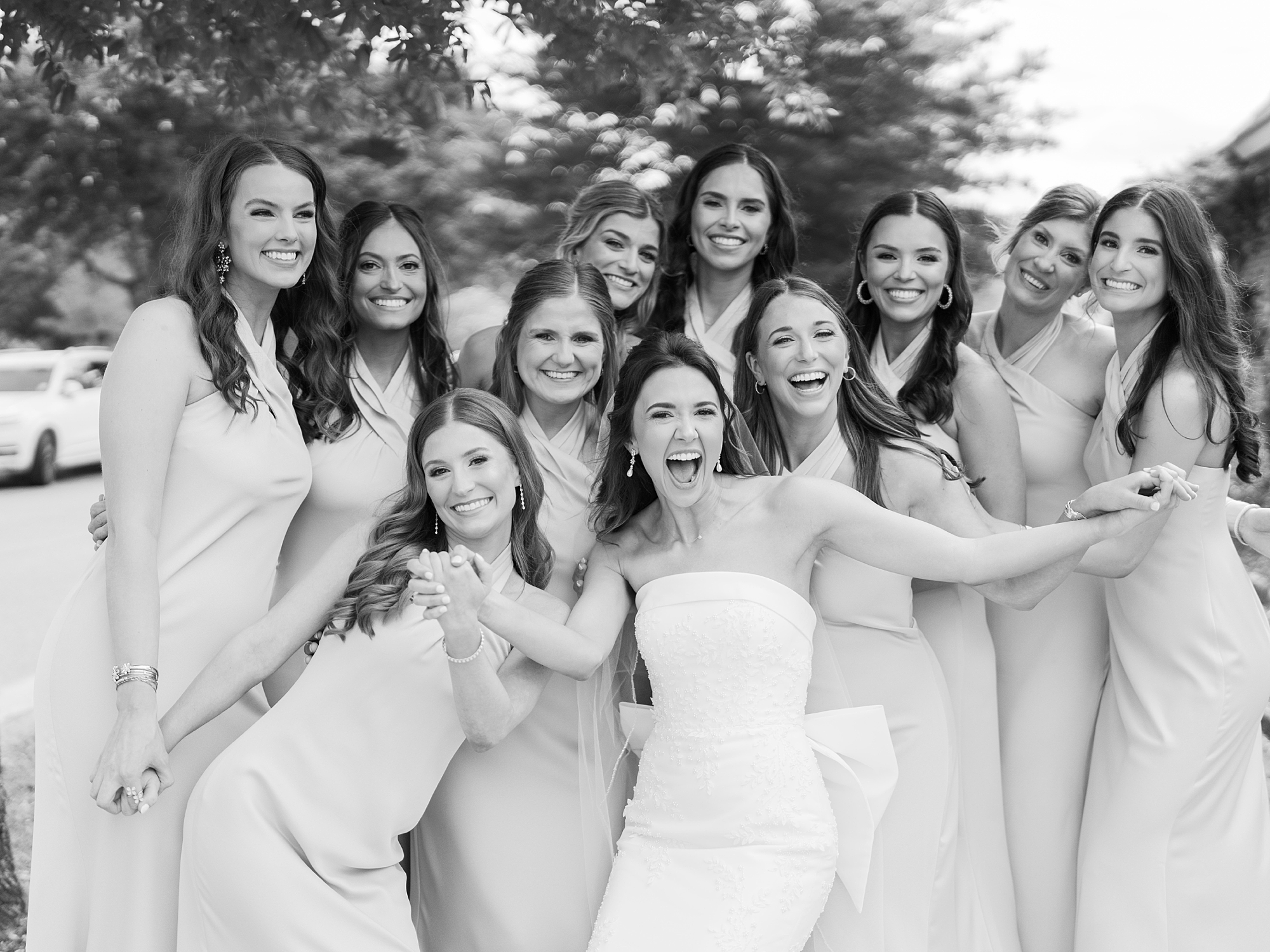 bride grins standing in front of bridesmaids during Lafayette LA wedding day