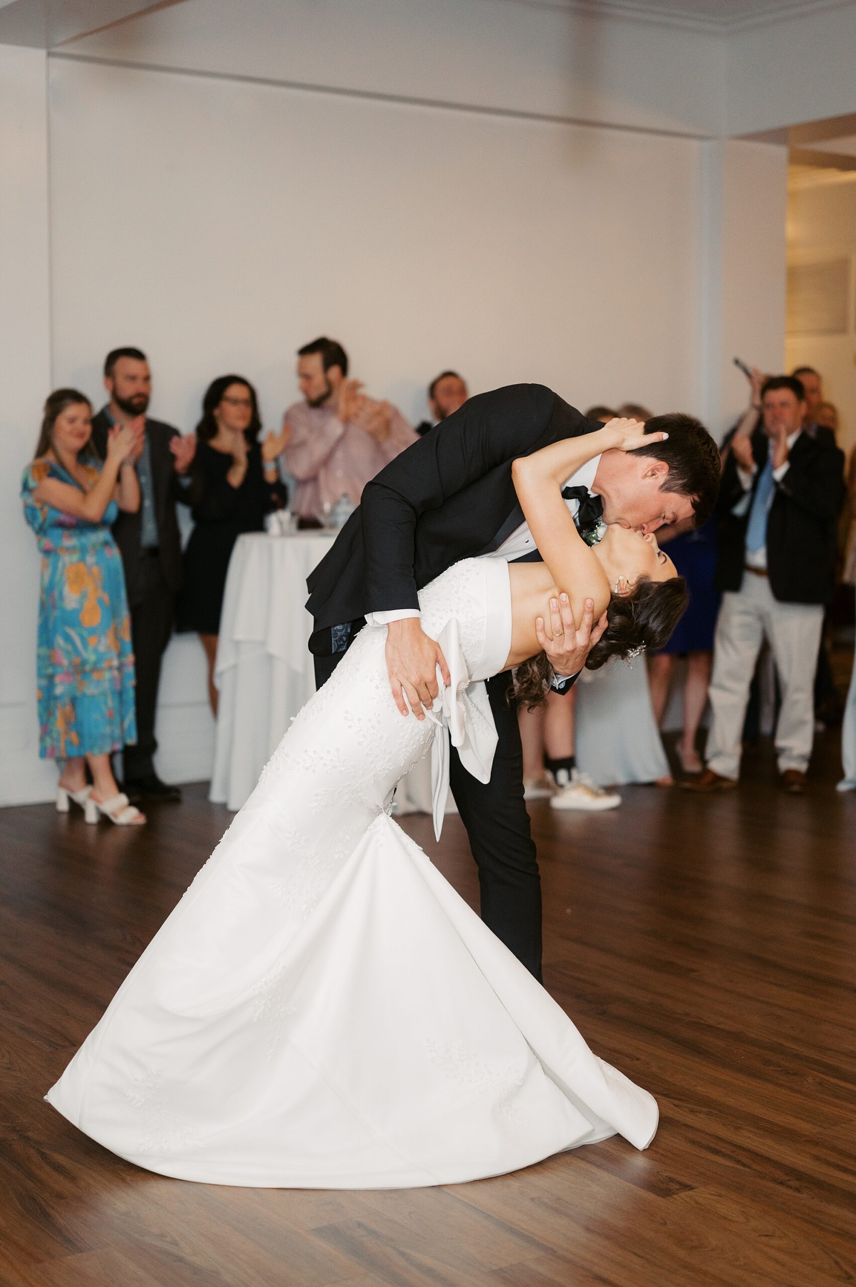 groom kisses bride on dance floor at Oakbourne Country Club