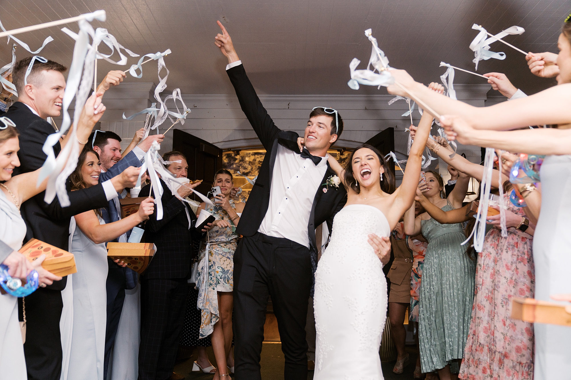 guests toss ribbons during reception dancing around newlyweds 