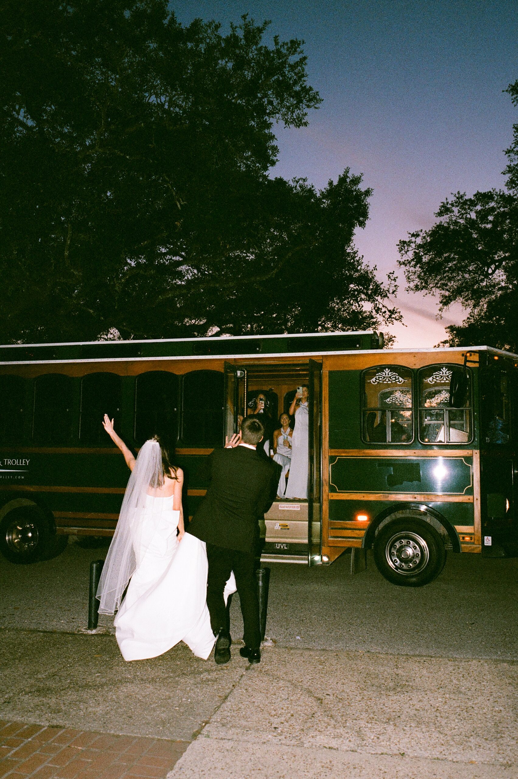 newlyweds cheer walking towards trolley in Lafayette LA