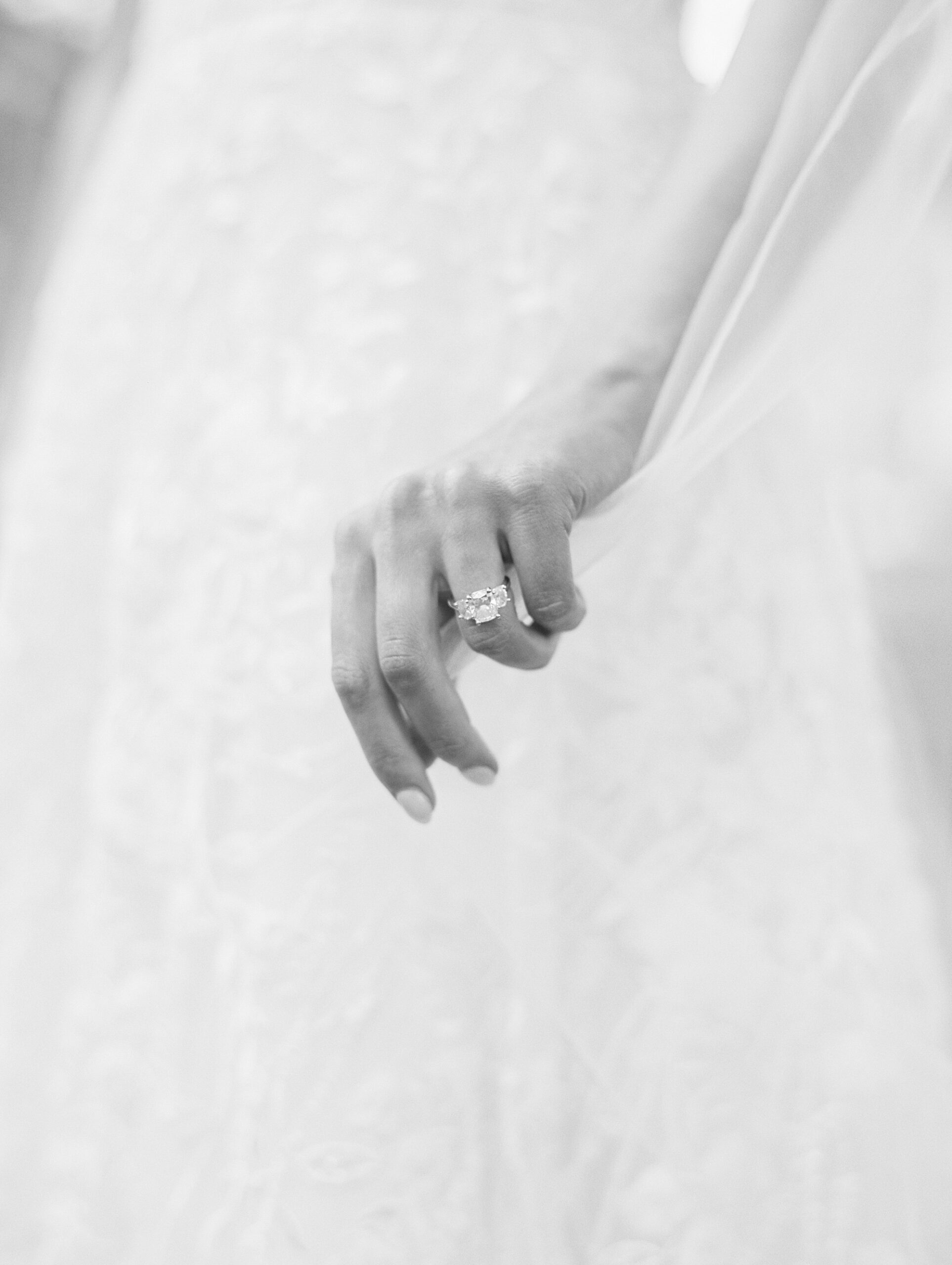 bride holds veil showing off engagement ring during Lafayette bridal portraits 