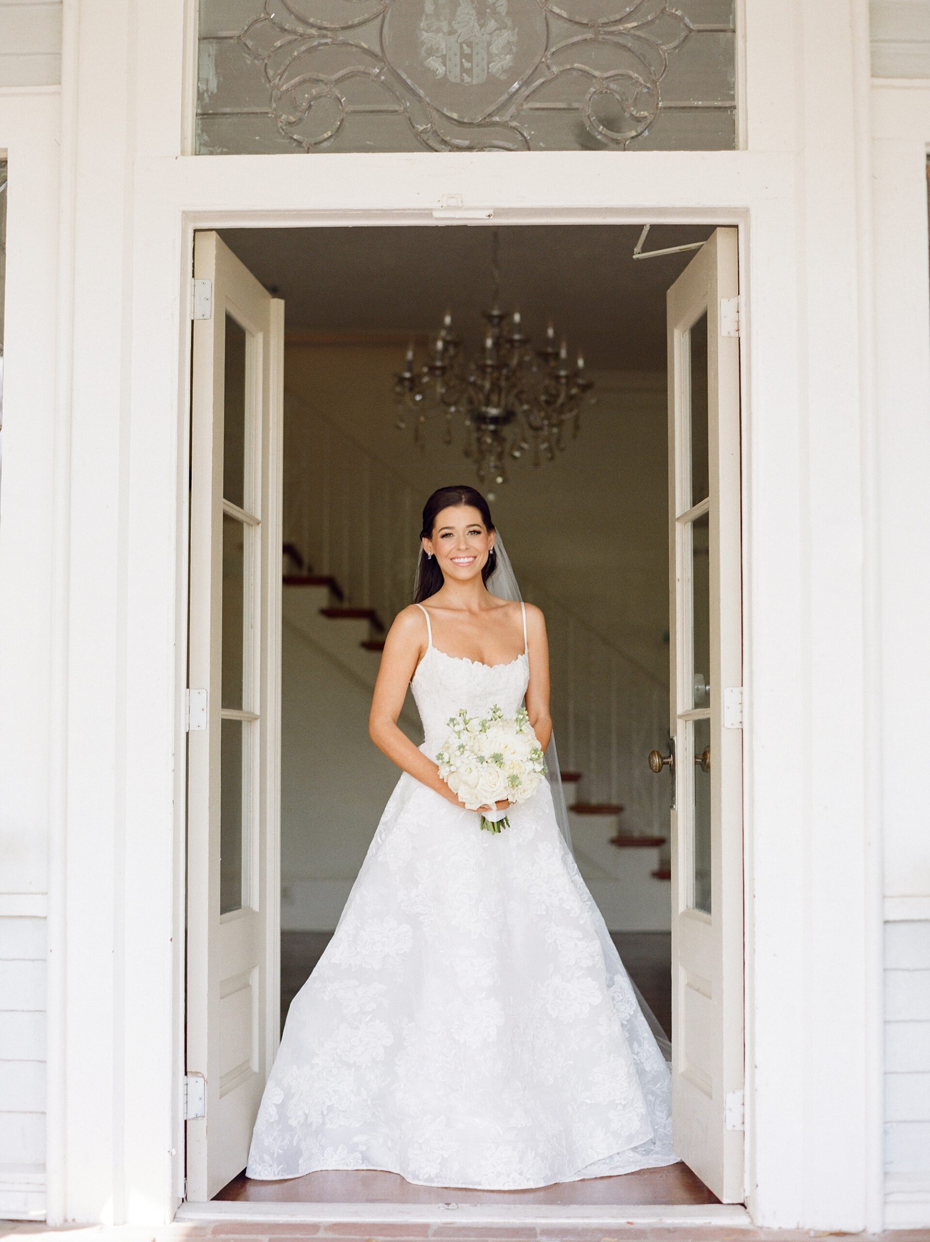 bride walks through open doors of John Nickerson House