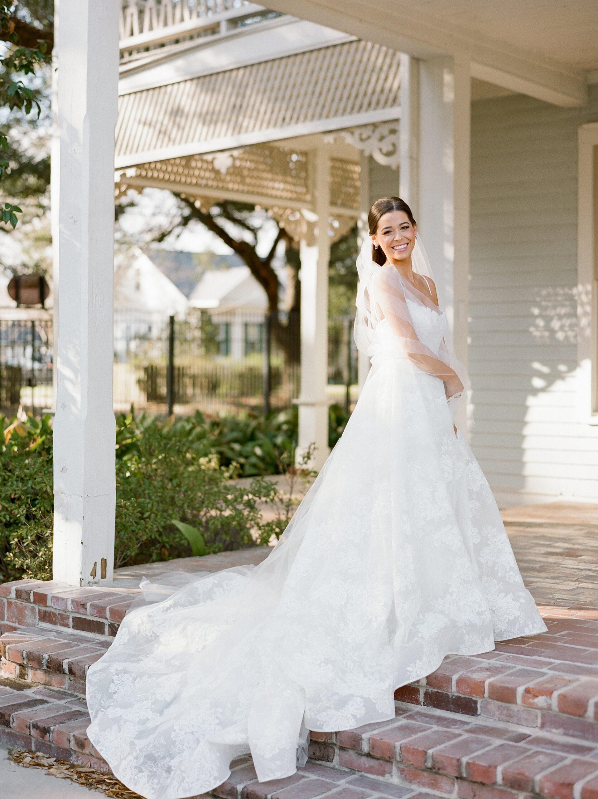 bride stands on front steps of the John Nickerson House in Lafayette LA