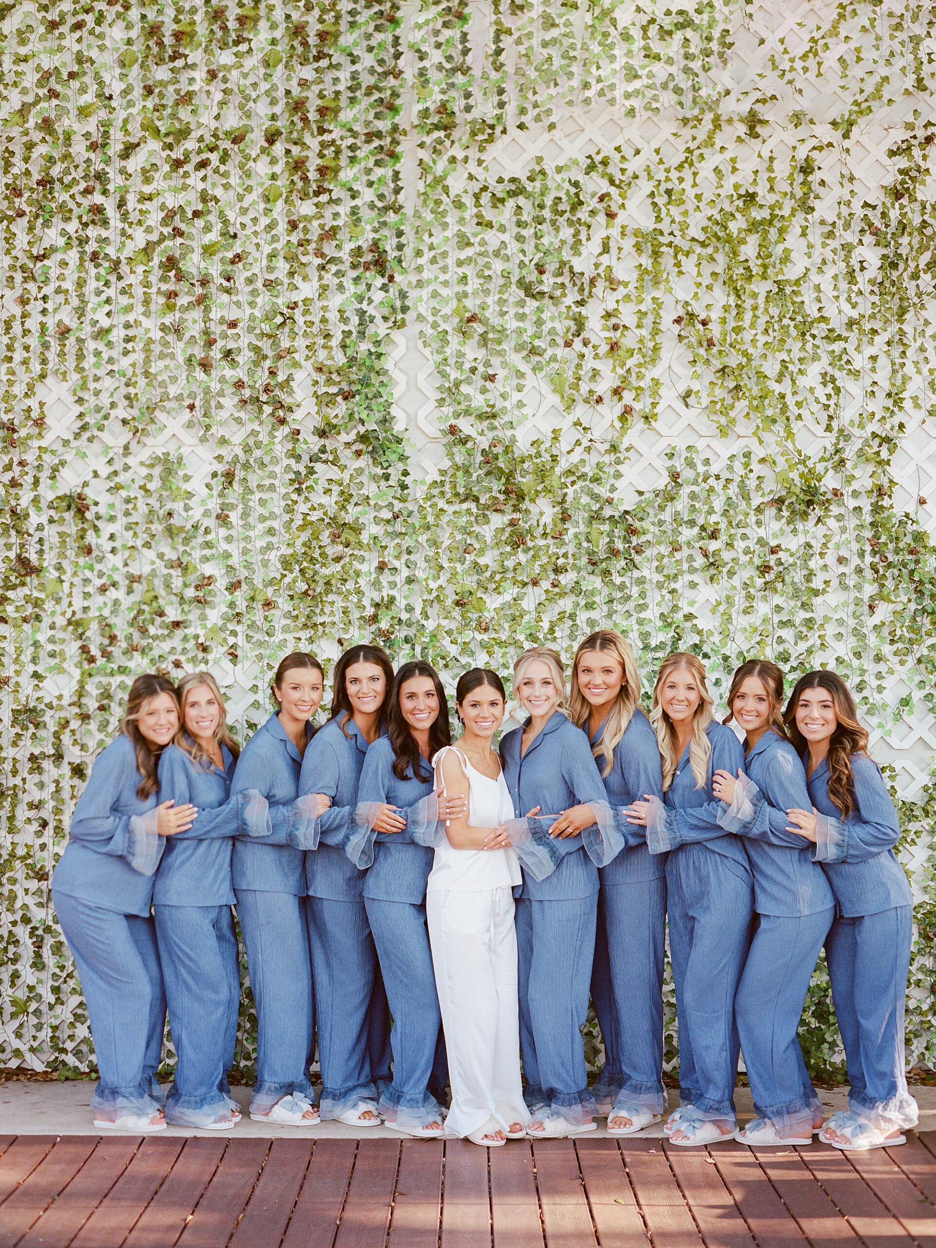 bride and bridesmaids pose in matching pajamas in Lafayette LA