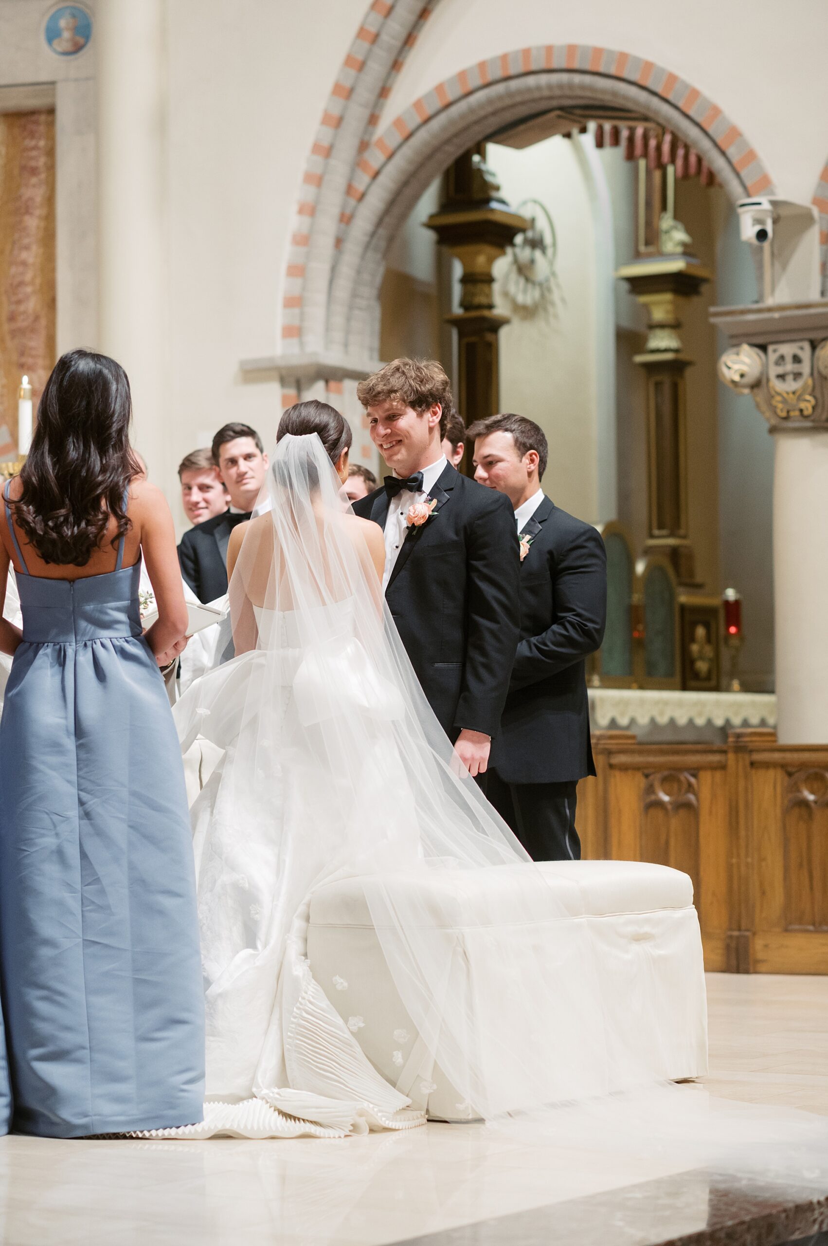 newlyweds lean at alter inside St. John's Cathedral