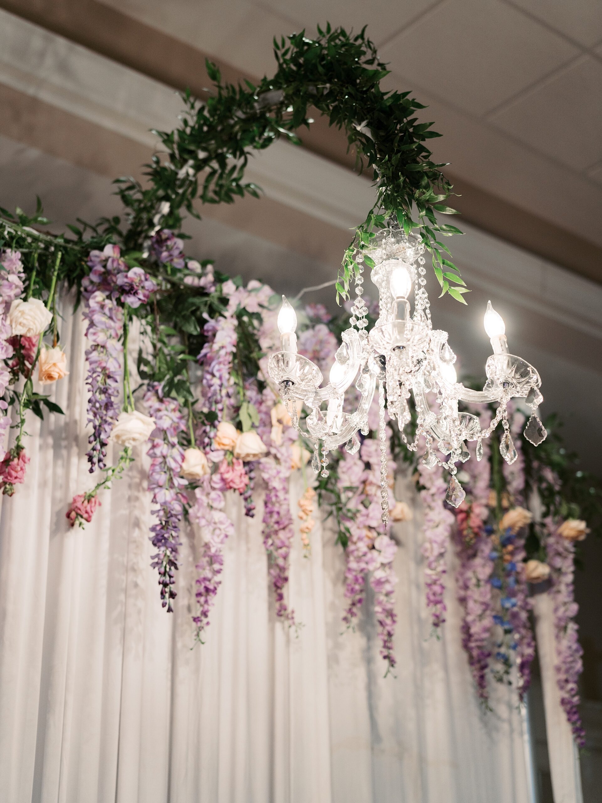 wedding flowers hang from ceiling at wedding reception at Le Pavillon