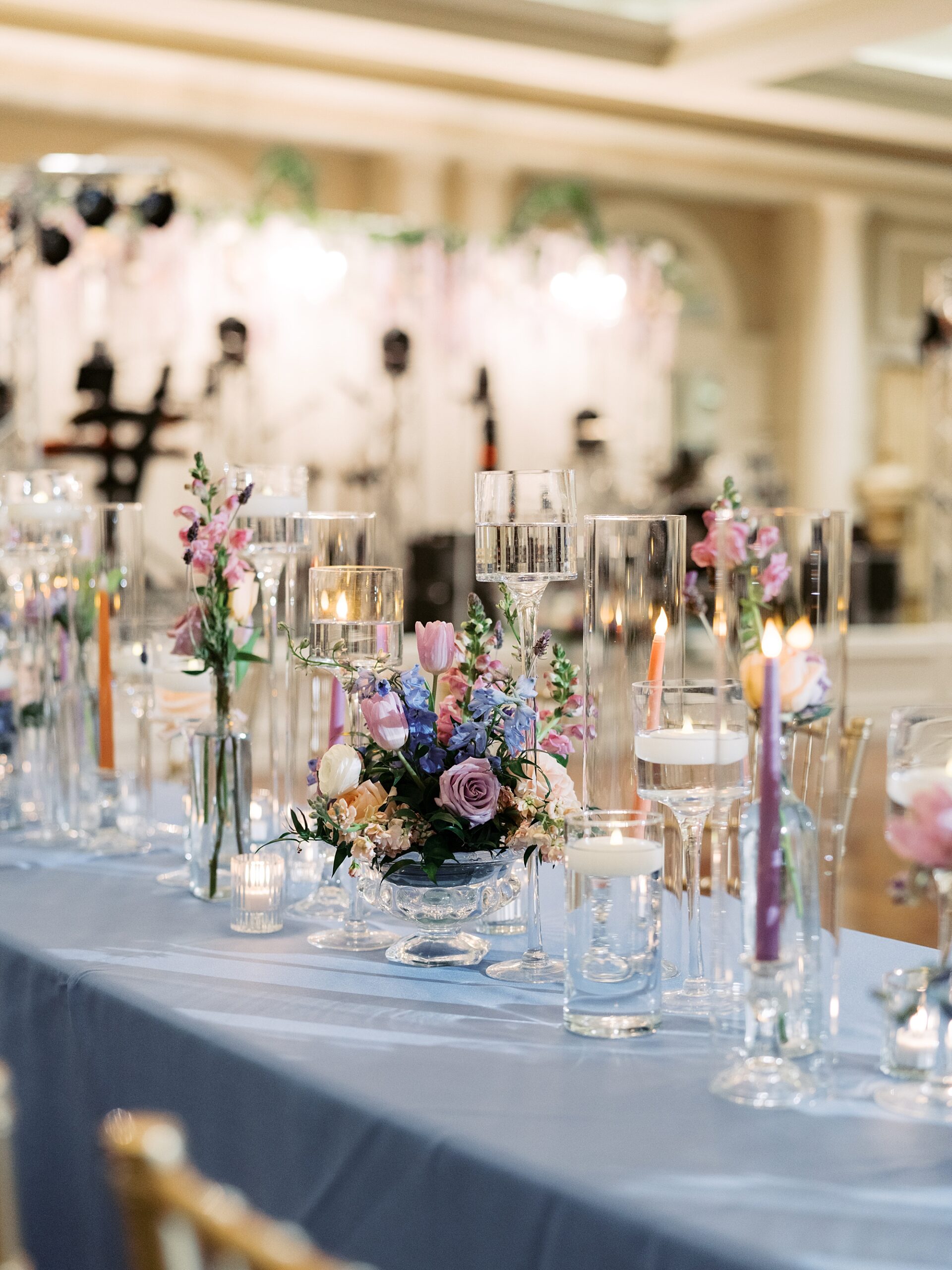 wedding reception at Le Pavillon with blue table cloths, blue candles, pink and blue flowers 