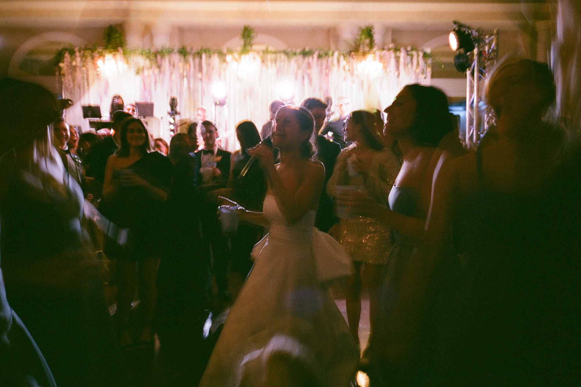newlyweds dance with guests at Le Pavilion wedding reception in Lafayette LA with glowsticks